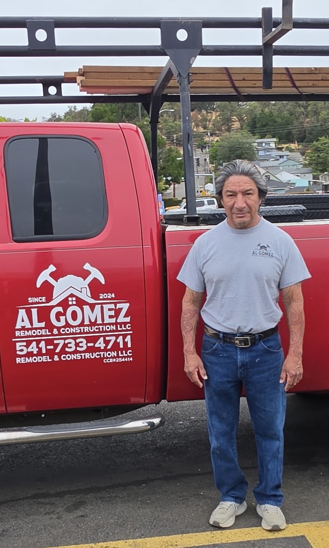 Al Gomez standing next to his Al Gomez Remodel & Construction work truck